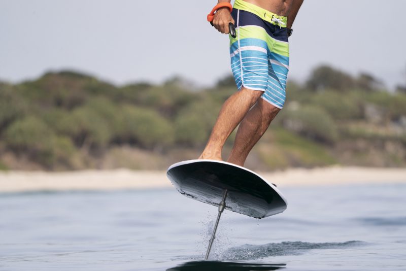 Man surfing the Fliteboard e-foil on calm water.