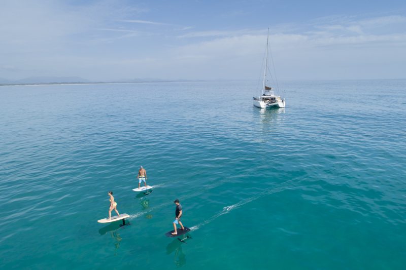 Three surfers riding the Fliteboard e-foil 