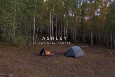 Camper sets up his tent and fire in Ashley National Forest