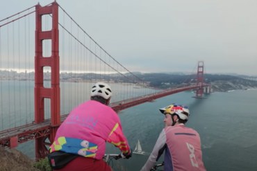 Two cyclists on their bikes looking at the Golden Gate Bridge