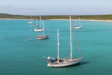 Sailboats anchored in crystal blue water