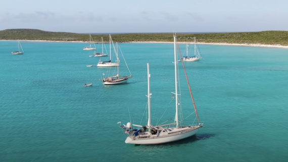 Sailboats anchored in crystal blue water