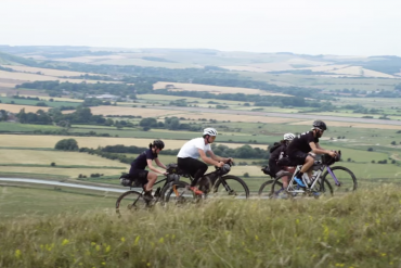 A group of cyclists ride gravel bikes on the South Downs Way trail in England