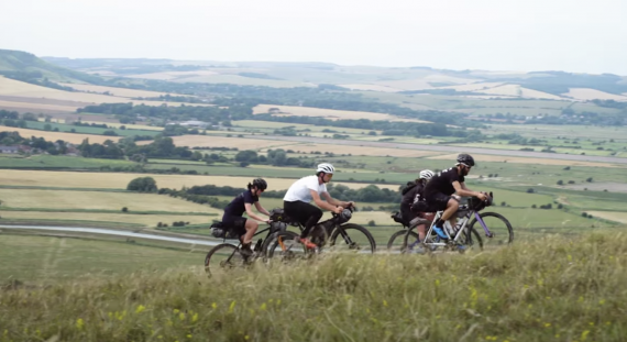 A group of cyclists ride gravel bikes on the South Downs Way trail in England