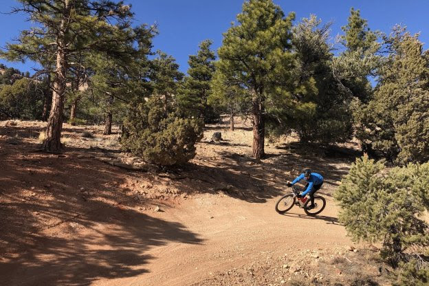 Man riding a gravel bike on a dirt trail in the high desert of Nevada