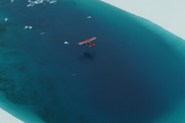 Bush place flying over a glacier lake in Alaska