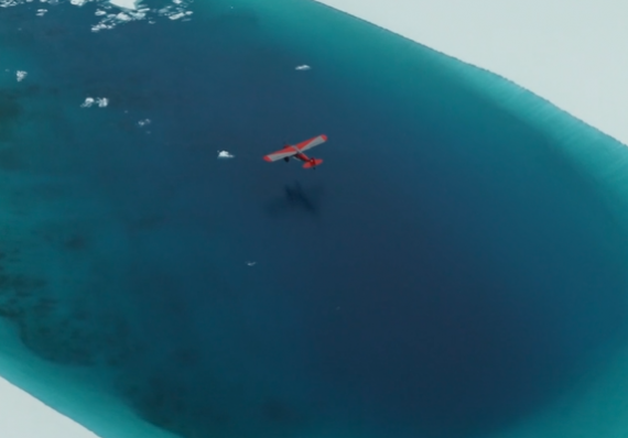 Bush place flying over a glacier lake in Alaska