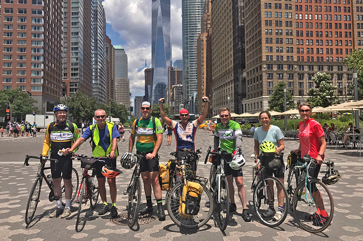 A group of cyclists finish their multi-day ride in Manhattan, NY