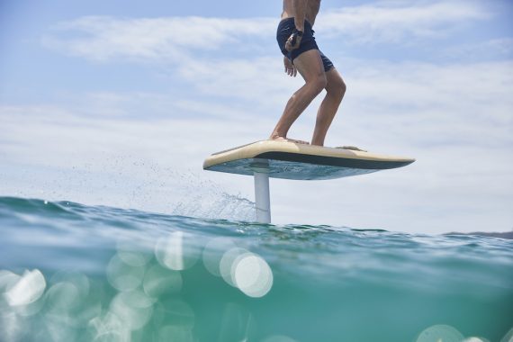 Man riding a FLITEBOARD electric Hydrofoil in the ocean near Byron Bay