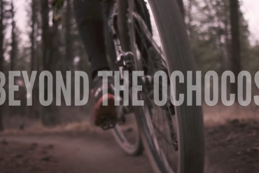 Zoomed in image of a person riding a mountain bike in the woods in the new film, Beyond the Ochocos