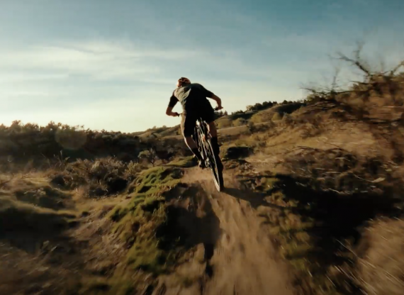 A man riding his new Niner JET 9 RDO mountain bike on a singletrack trail