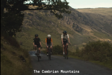 Three ladies riding road bikes up a mountain road in Wales