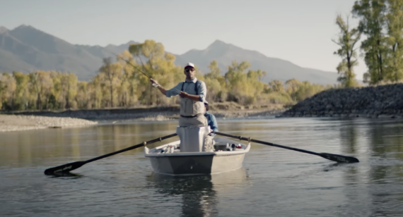 Stio Ambassador and chef Ranga Perera fly fishing on a calm river in a small boat