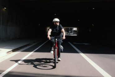 A man riding his Trek Allant+ eBike in the bike lane