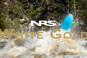 A whitewater kayaker paddling a rough river in Idaho