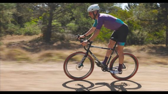 Ben Frederick riding his Ritchey cross bike on a dirt road in his Small Monsters Project kit.