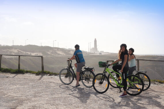 A family taking a picture on the side of a coastal cliff in Portugal