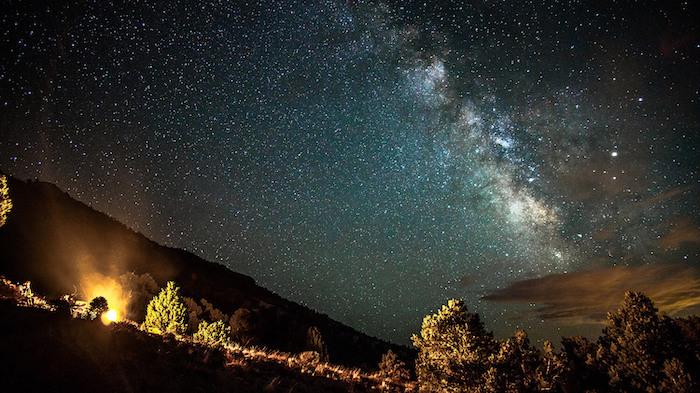 A view of the stars and milky way from a hillside in the Sierra Nevada mountain range.