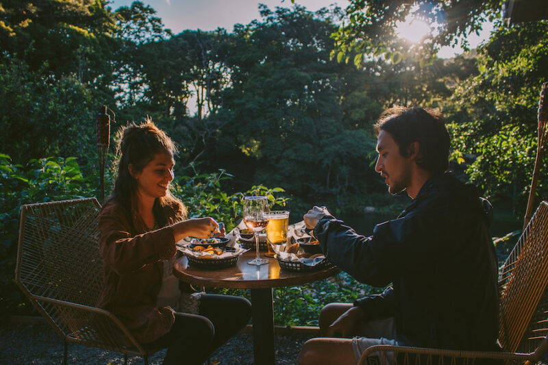 Two adults enjoying drinks and a meal in Costa Rica's Cloud Forest at Hotel Belmat