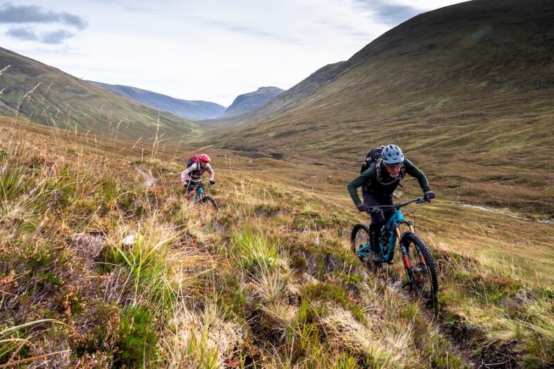 Two mountain bikers on singletrack in the Scottish Highlands