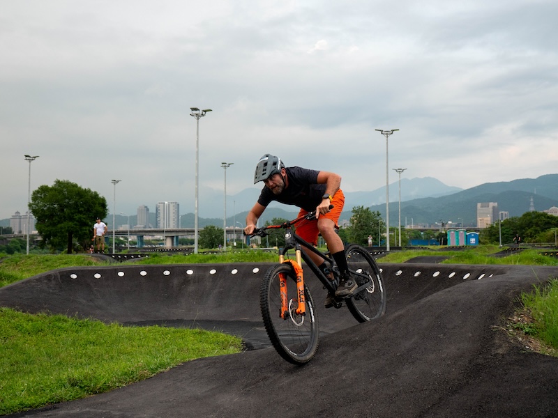 A professional mountain biker riding a pump track in Taipei